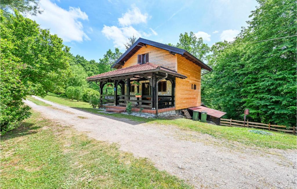 a wooden cabin in the middle of a dirt road at 2 Bedroom Gorgeous Home In Gornje Stative in Gornje Stative