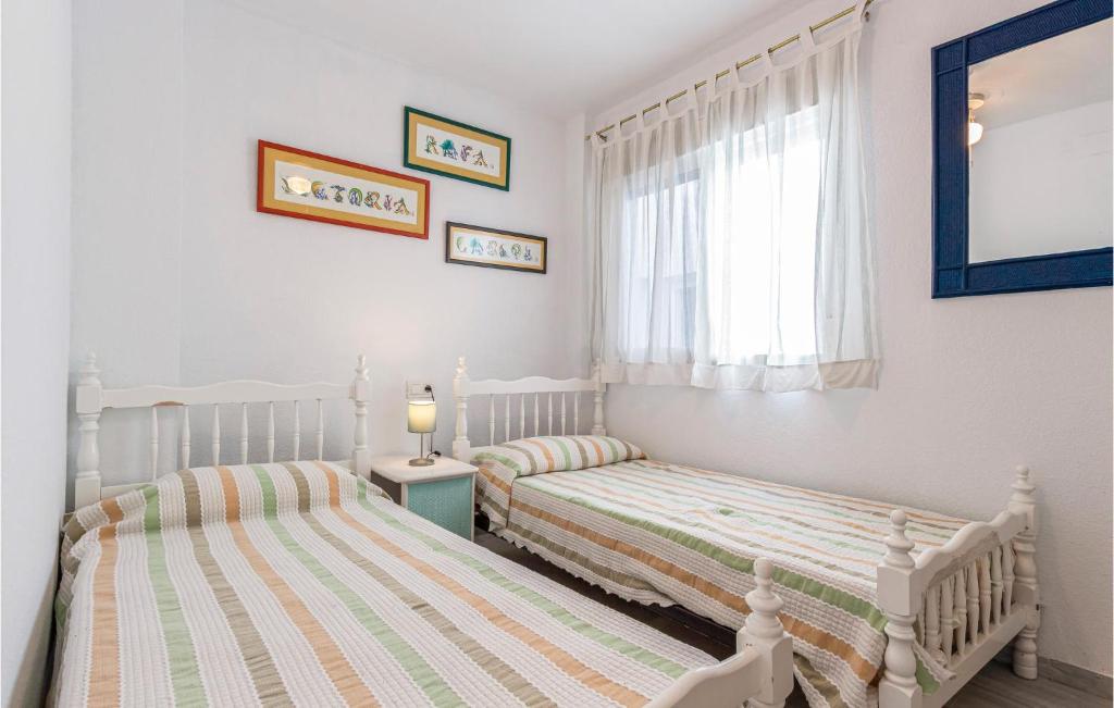A bed or beds in a room at 2 Bedroom Nice Apartment In Torrox