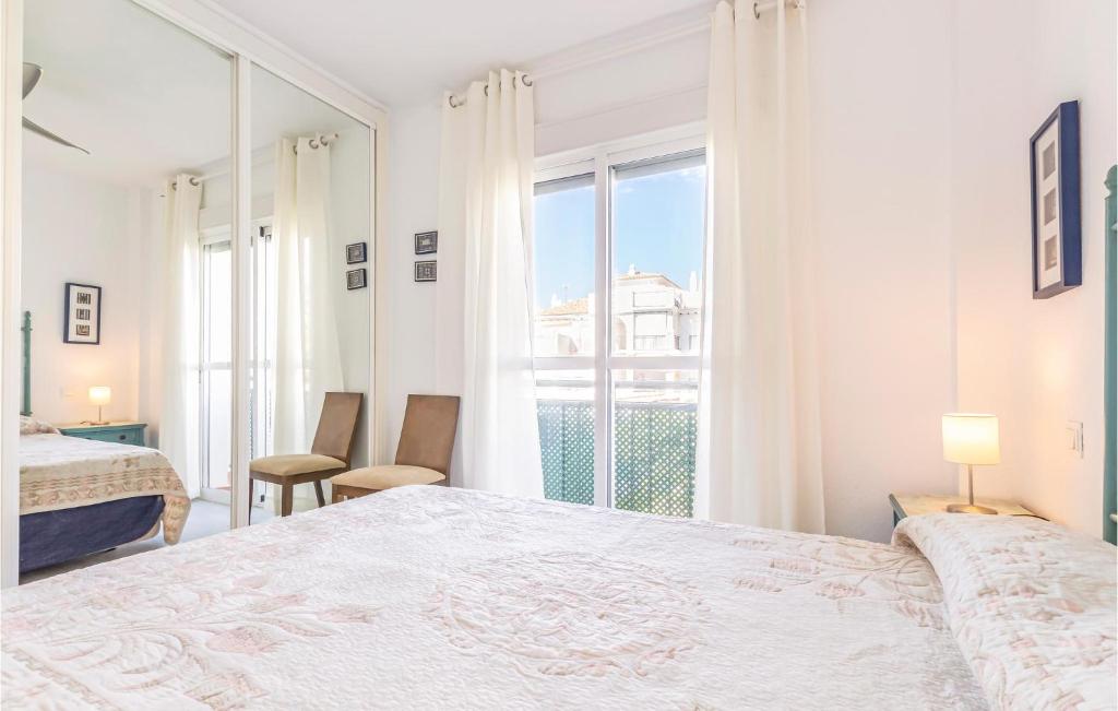 A bed or beds in a room at 2 Bedroom Nice Apartment In Torrox