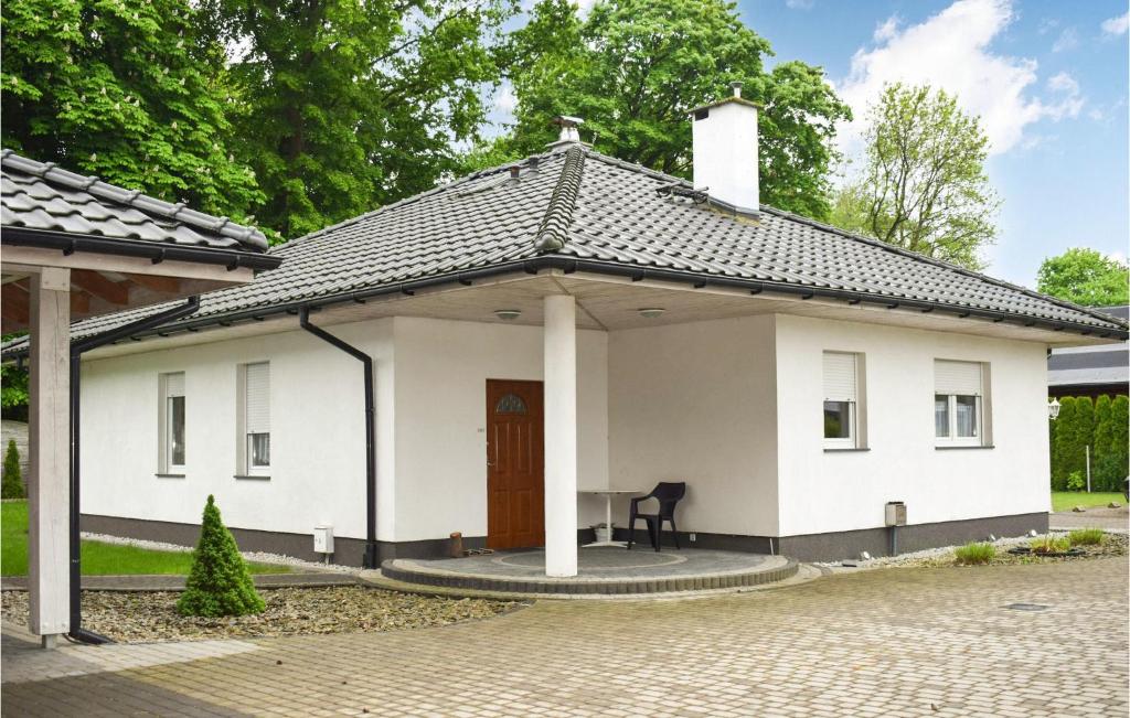 a small white house with a porch at Awesome Home In Wrzosowo With 2 Bedrooms And Wifi in Wrzosowo