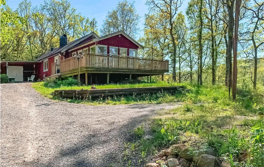 a house in the woods with a large deck at Beautiful Home In Yngered With Wifi 