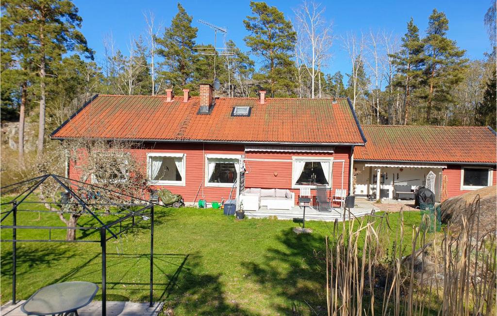 a red house with a red roof and a yard at 4 Bedroom Nice Home In Trosa in Trosa