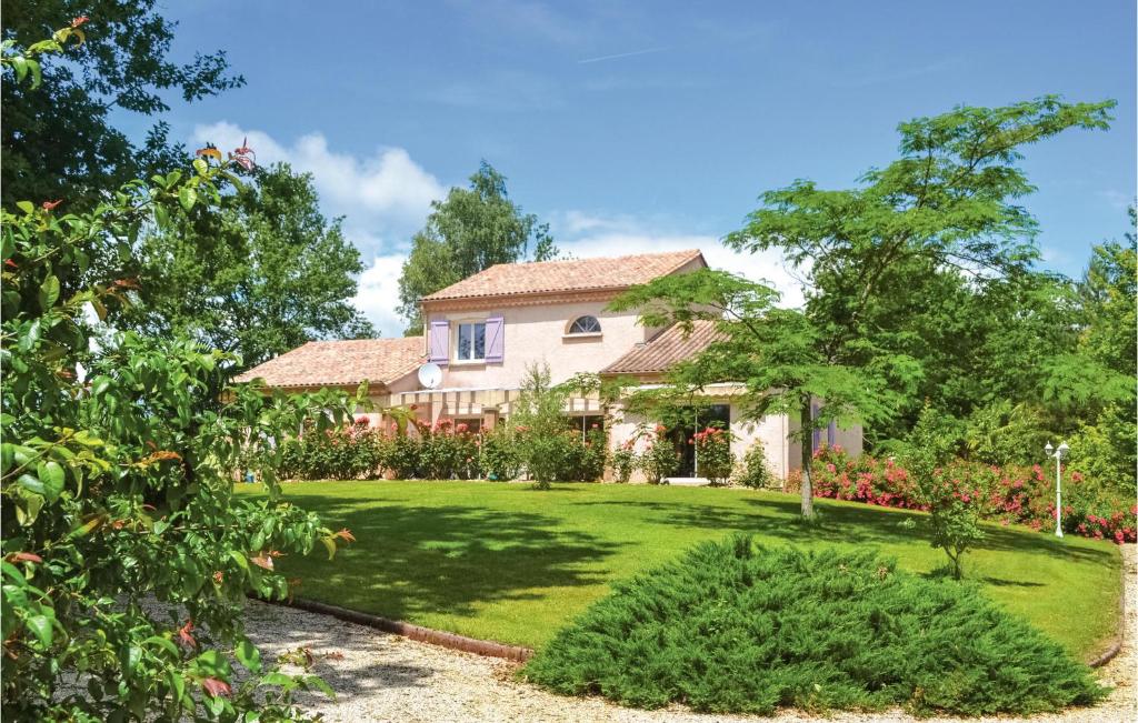 a house with a green yard with trees and bushes at Cozy Home In Payzac With Kitchen in Payzac