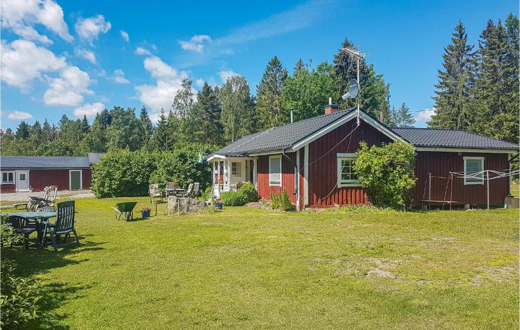 a small house in a yard with a table at Nice Home In Ljusne With Wifi in Ljusne