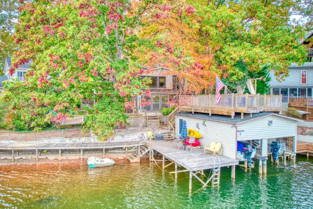 a house on a dock on a body of water at Dancing Waters in Lake Lure
