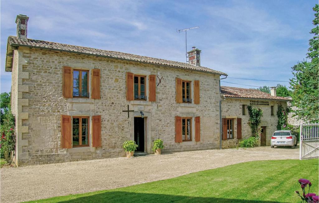 a stone house with a car parked in front of it at Awesome Home In Souvigne With 5 Bedrooms, Private Swimming Pool And Heated Swimming Pool in Souvigné