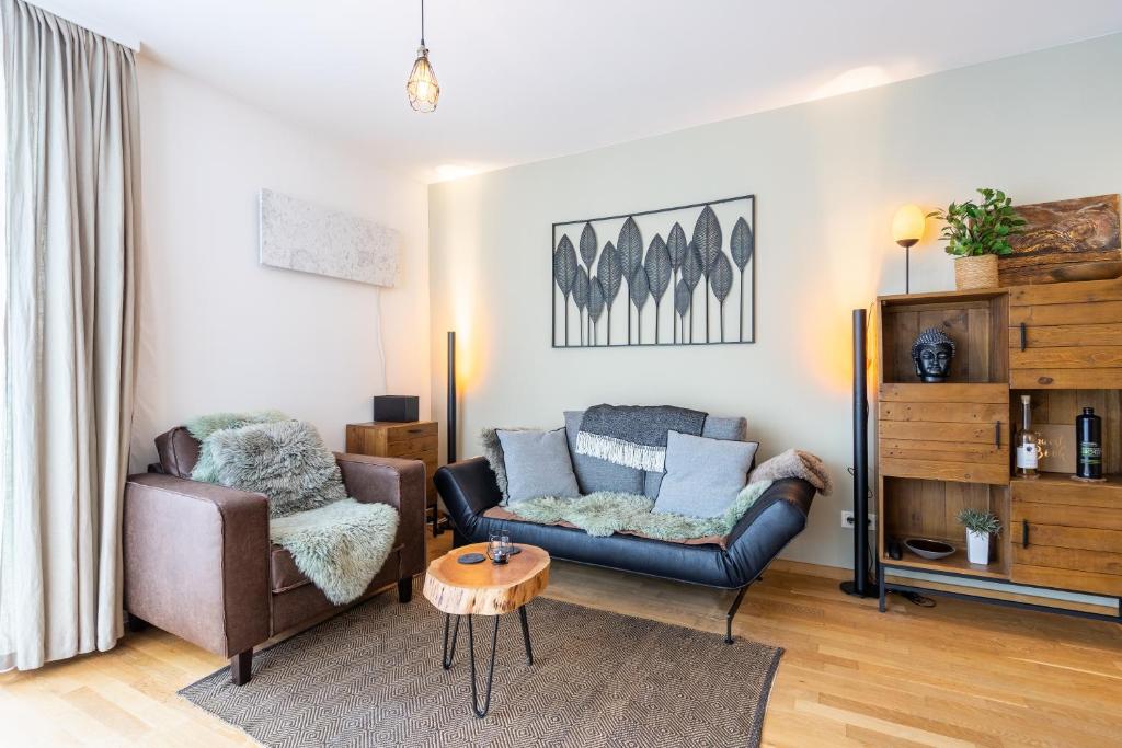 a living room with a couch and a chair at Steinadler Monte - Skiing Holiday in Obertauern in Obertauern