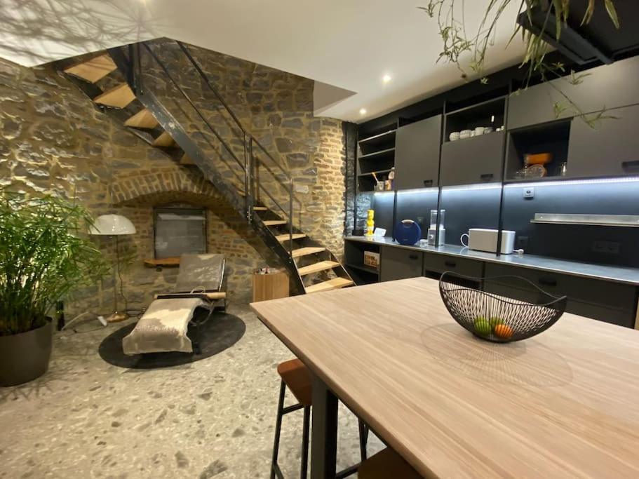 a dining room with a table and a staircase at Maison de vacances la Grange 20 min de namur 