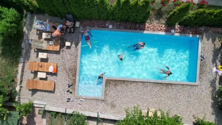 a large swimming pool with people in the water at Apartmani ,,Vasa ,, 1 in Soko Banja