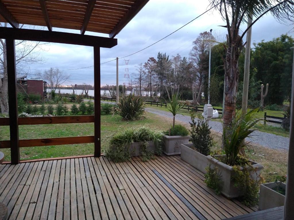 a wooden deck with plants in a park at CARELHUE GUAZU 1 in Villa Paranacito