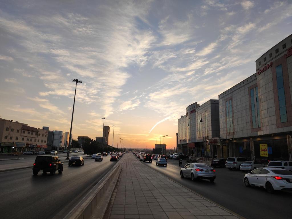a city street filled with lots of traffic at sunset at Brzeen Hotel Riyadh in Riyadh
