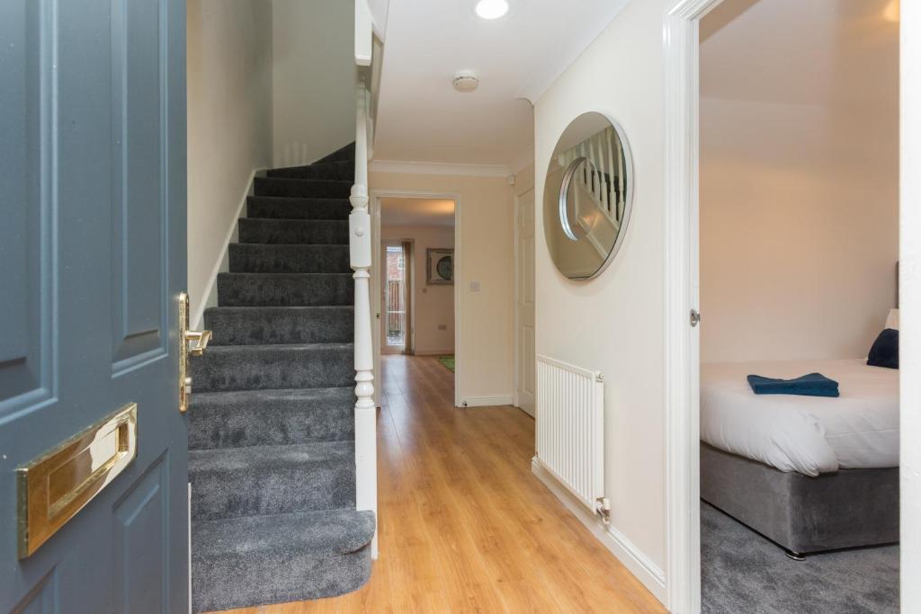 a hallway with a staircase leading to a bedroom at Great Park Townhouse in Preston