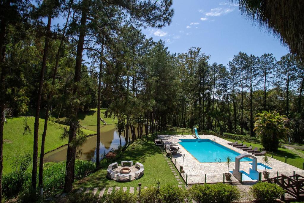 een uitzicht over een zwembad in een tuin bij Sítio com lazer completo e natureza em Guararema in Jacareí