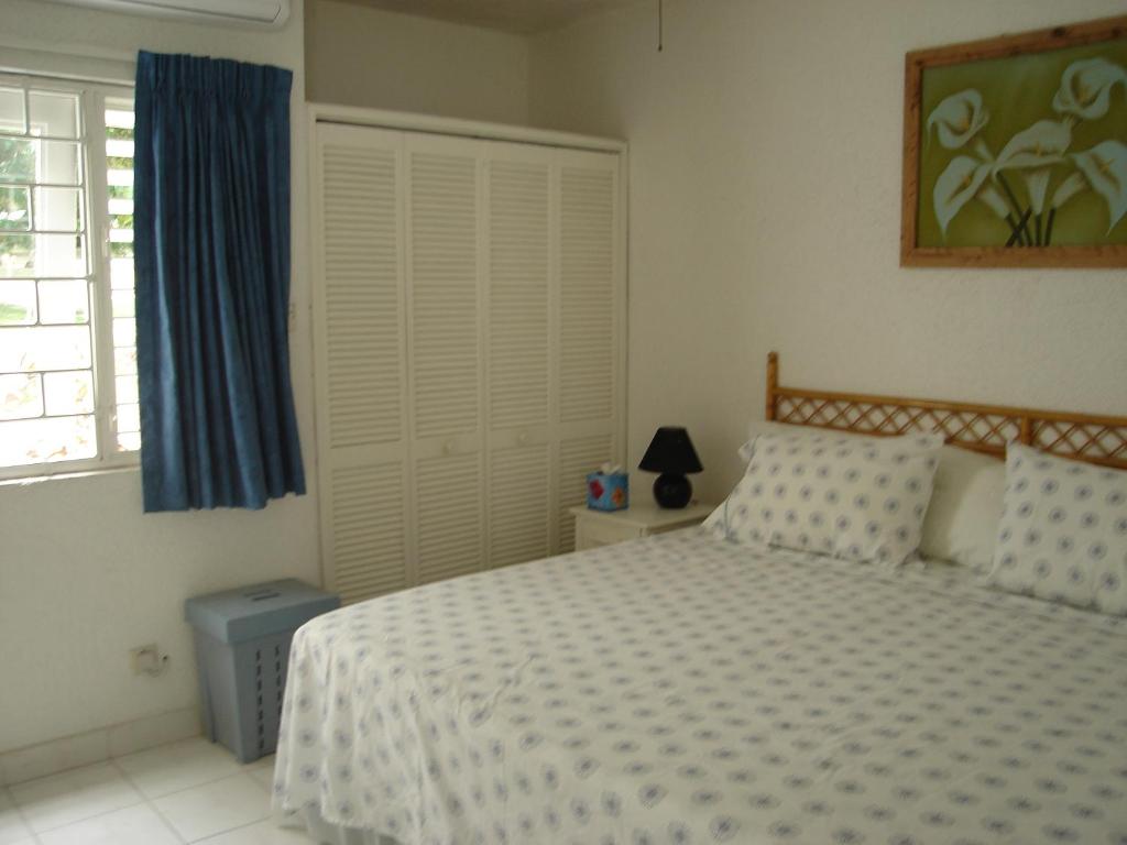 a bedroom with a bed and a window at 213 Golden Grove, Rockley in Bridgetown