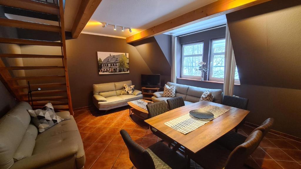 - un salon avec une table et un canapé dans l'établissement Appartements im "Landhaus am Frohnauer Hammer", à Annaberg-Buchholz