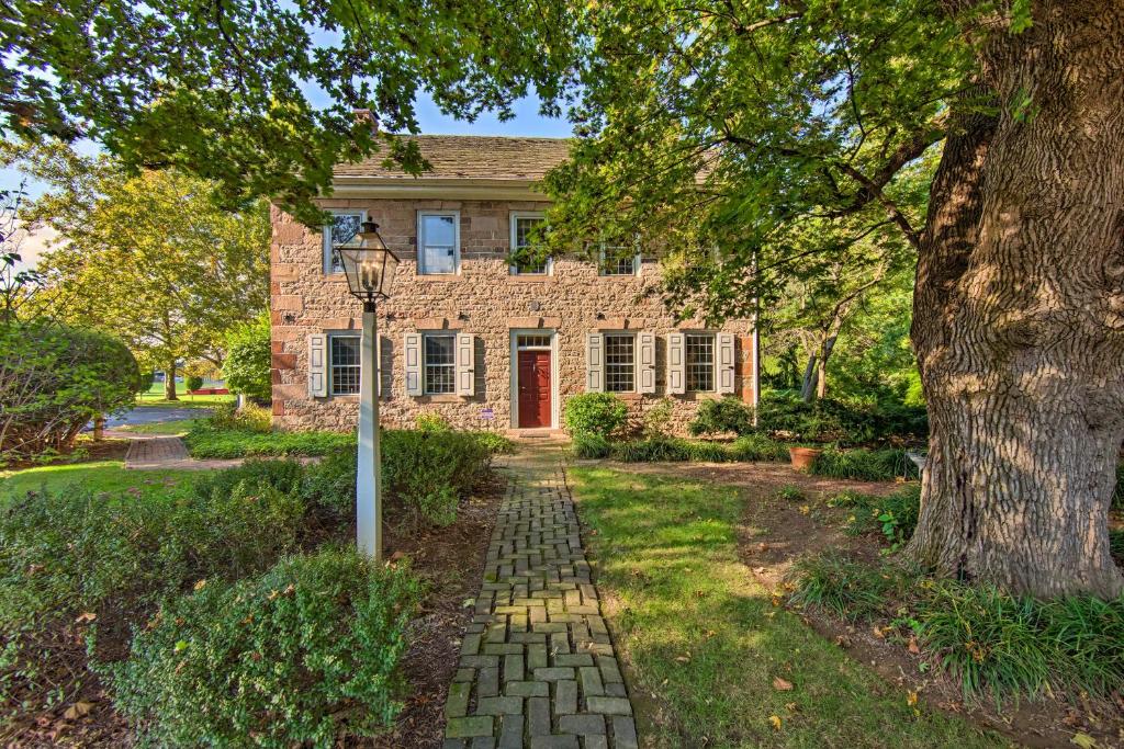 a brick house with a tree and a street light at Beautiful Historic House In Amish Country in Ephrata