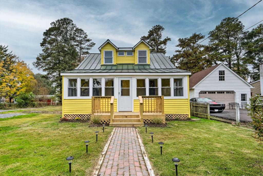 une maison jaune avec un toit gris dans l'établissement Updated North Beach Cottage Pet Friendly!, à Deale