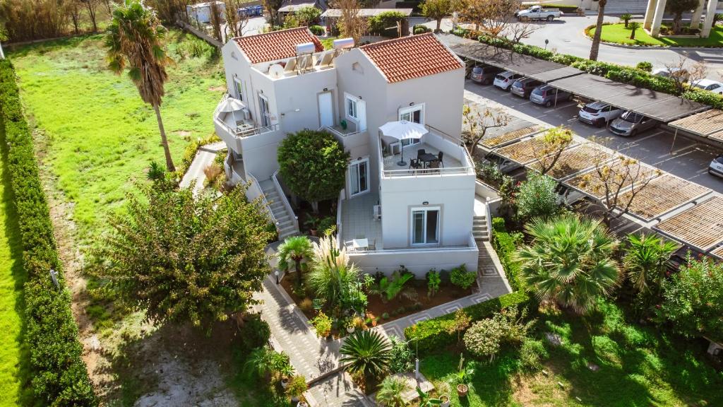 an aerial view of a white house with palm trees at Gelina Apartments in Plataniás