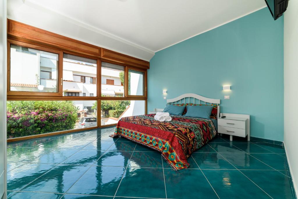 a bedroom with a bed and a swimming pool at Il Papavero Residence Arbostella in Salerno