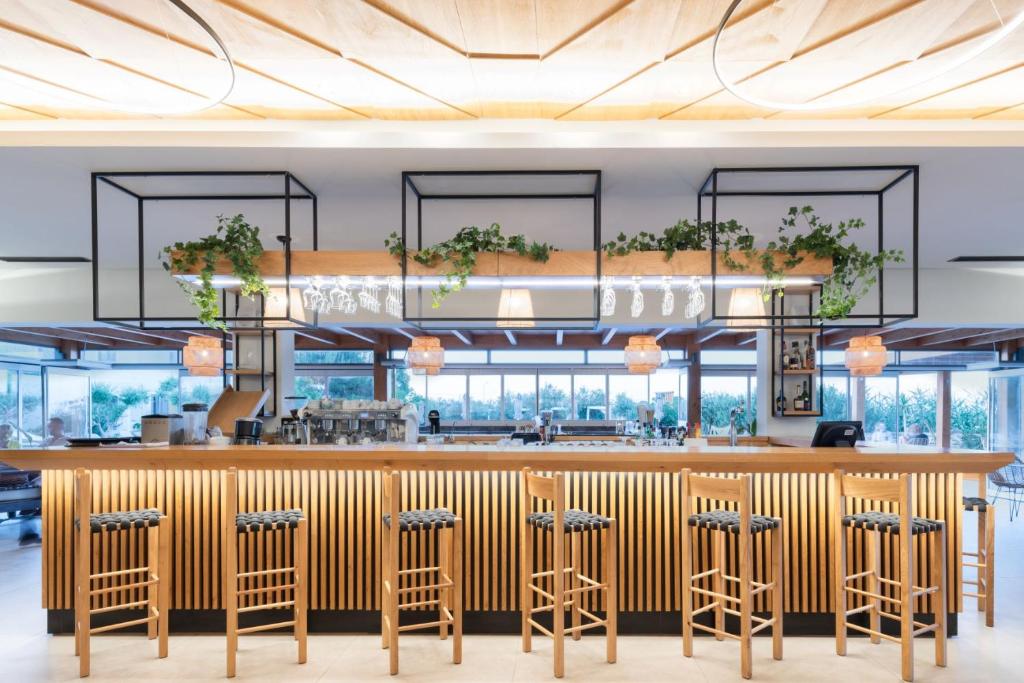 a rendering of a restaurant with a bar and stools at Malena Hotel & Suites - Adults Only by Omilos Hotels in Amoudara Herakliou