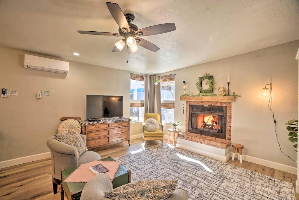 a living room with a fireplace and a ceiling fan at Williams Studio on Famous Route 66 with Fireplace! in Williams