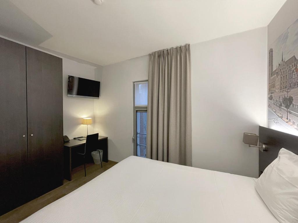 Postel nebo postele na pokoji v ubytování 3 Paardekens - City Centre Hotel