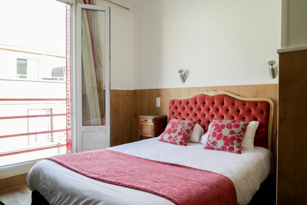 Postel nebo postele na pokoji v ubytování Hôtel Gloria