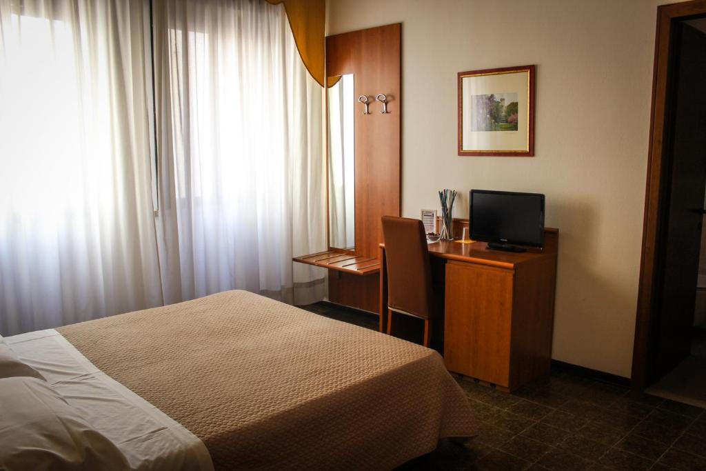 Postel nebo postele na pokoji v ubytování Hotel Centrale