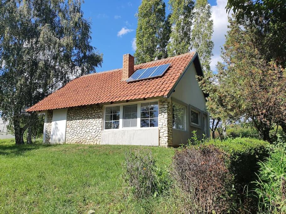 a house with a solar panel on the roof at Kućerak Višnja in Manđelos