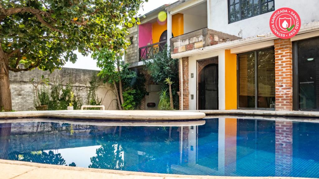 a house with a swimming pool in front of a building at Casa Madero in Oacalco