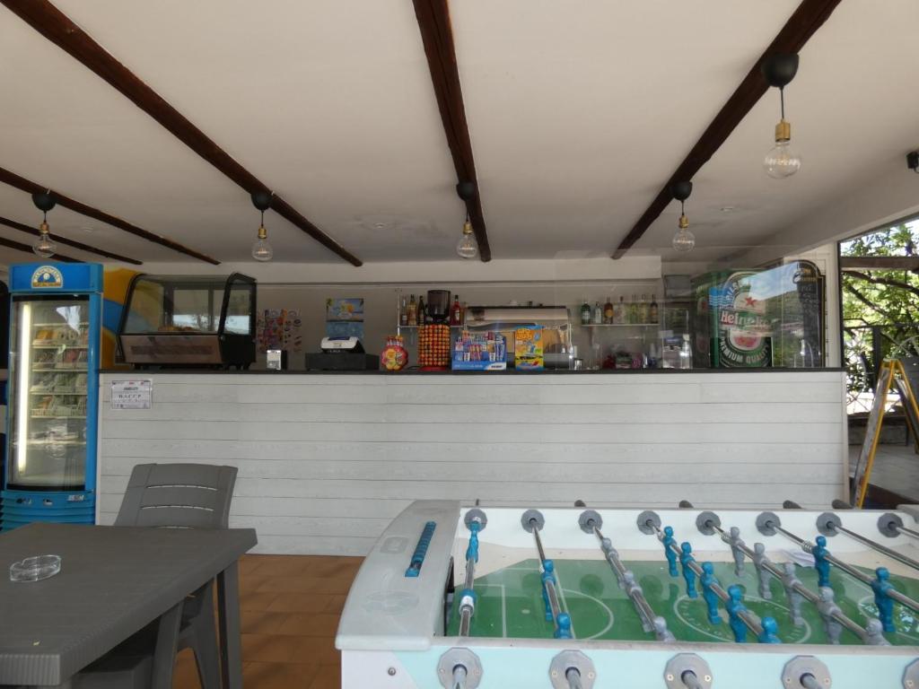 a kitchen with a counter with a sink with tooth brushes at Cardiff Hotel in Marina di Camerota