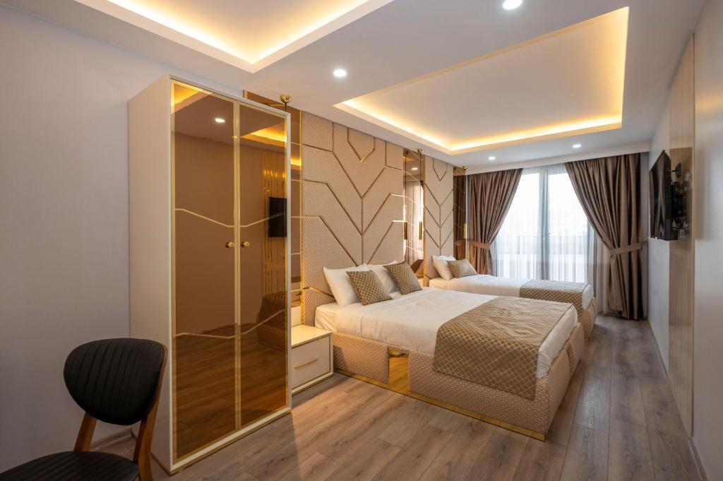 a bedroom with a bed and a glass shower at Luxury Airport Hotel in Arnavutköy