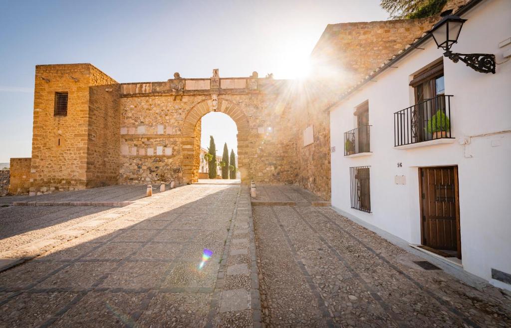 an alley in an old building with an archway at Casa Remotti in Antequera