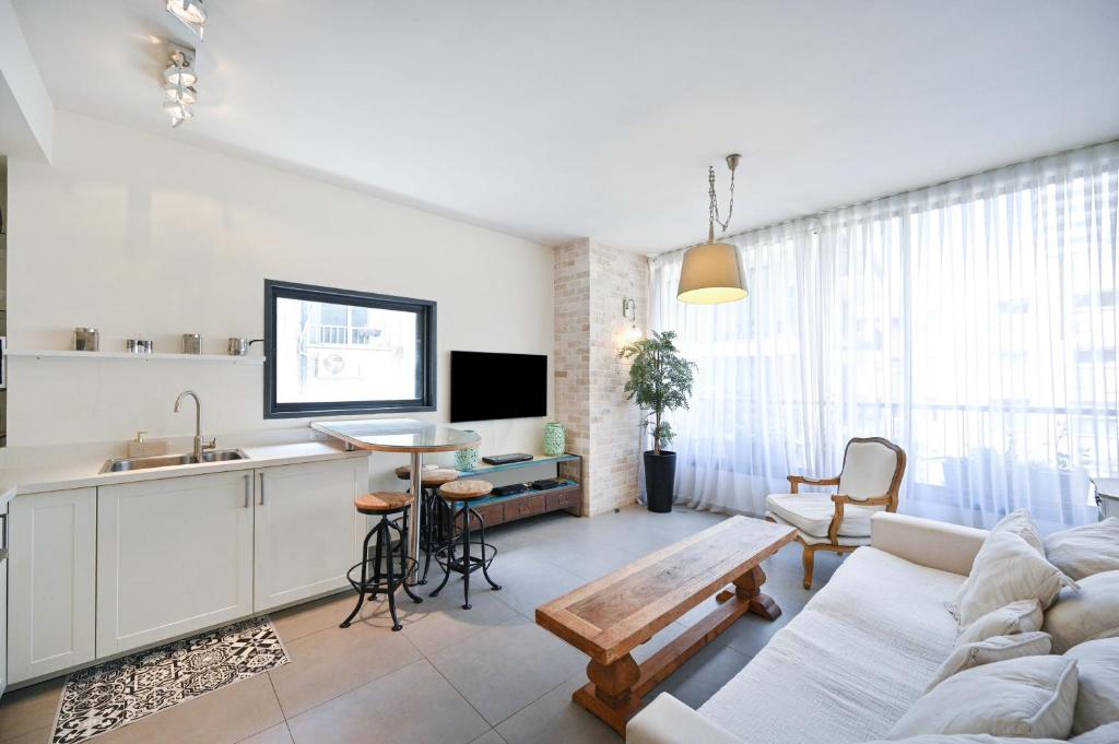 a living room with a couch and a table at Hess st close to the beach by HolyGuest in Tel Aviv