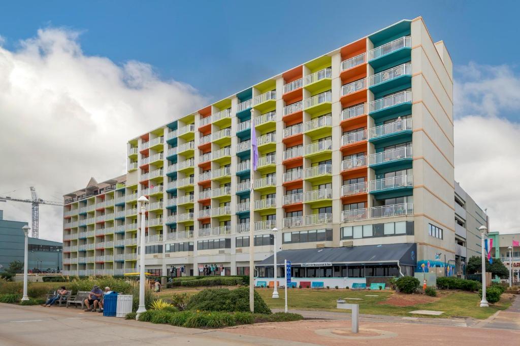 a large building with colorful balconies on a street at Sandcastle Resort in Virginia Beach