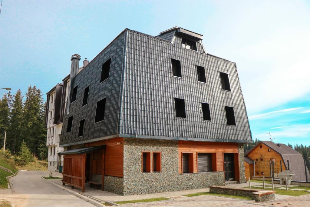 a building with a metal roof on top of it at My sweet home Jahorina in Jahorina