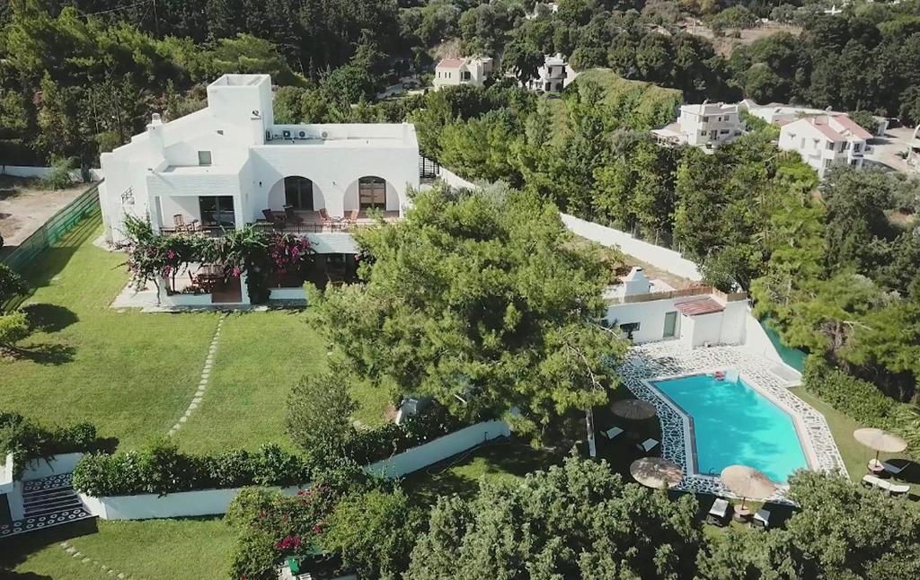 an aerial view of a house with a swimming pool at Rodos Paradise Villa in Koskinou