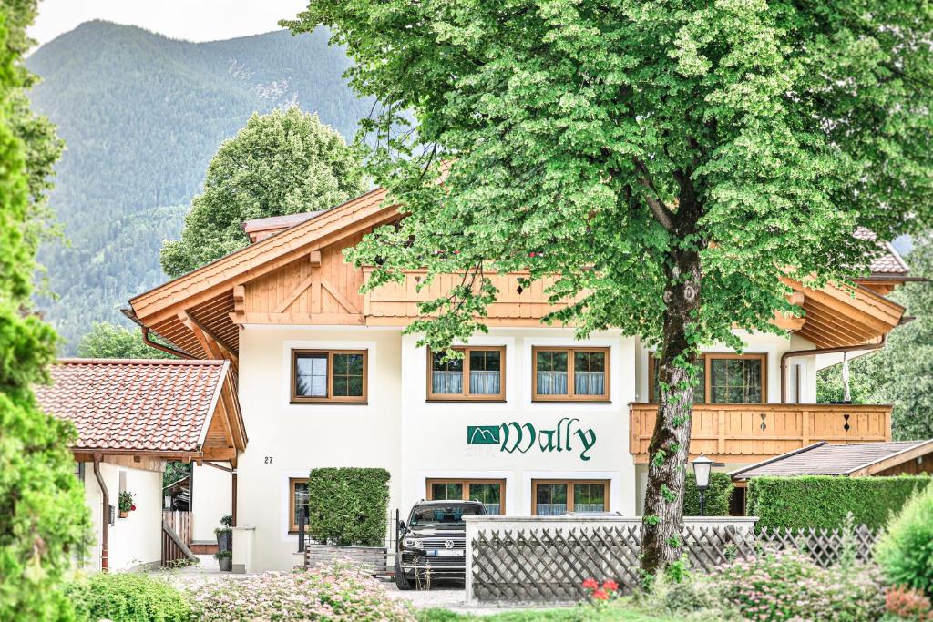 a house with a sign that reads family at Ferienwohnungen "Zur Wally" in Garmisch-Partenkirchen