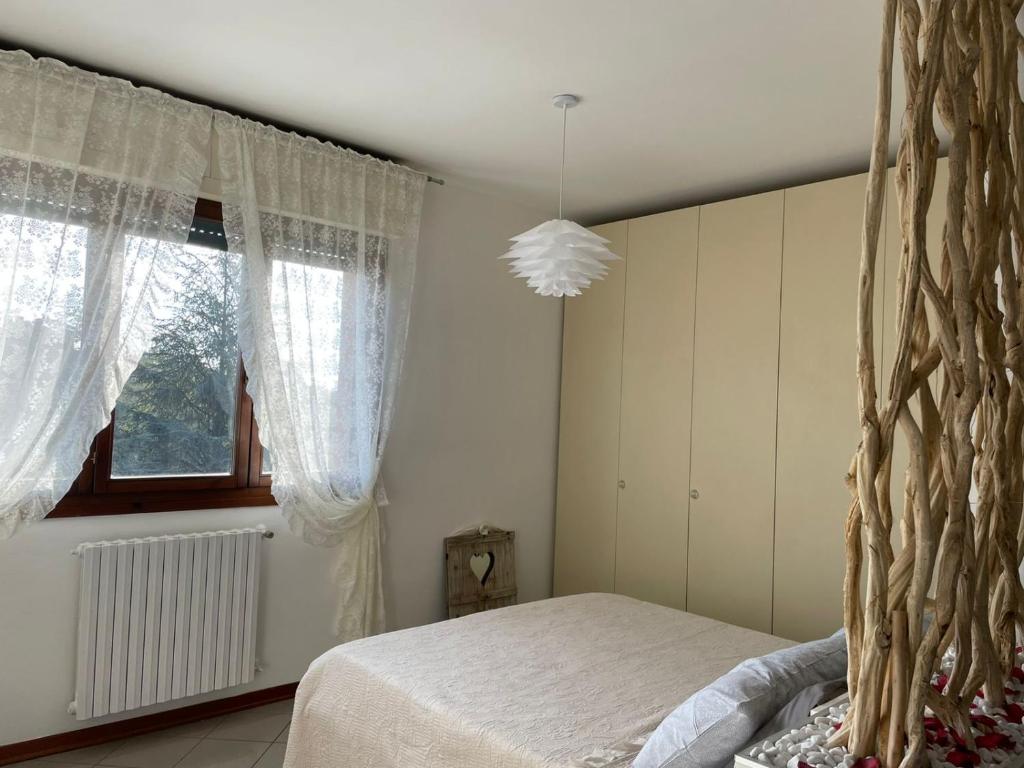 a bedroom with a bed and a large window at Apartment "La Balotta" in Bologna