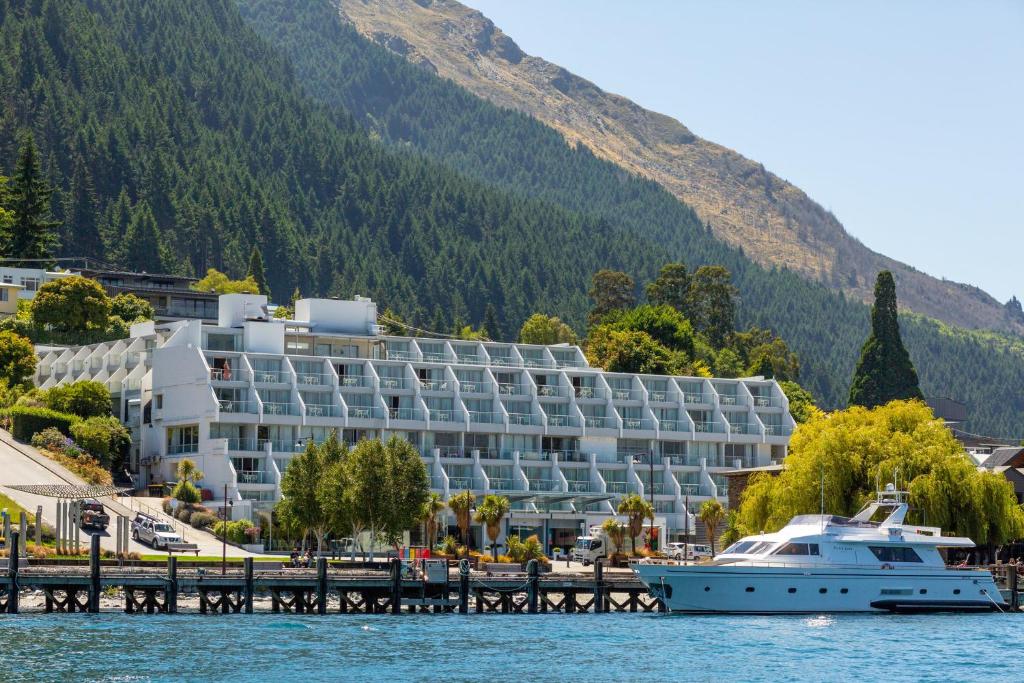 un bateau de croisière devant un hôtel sur l'eau dans l'établissement Crowne Plaza Queenstown, an IHG Hotel, à Queenstown