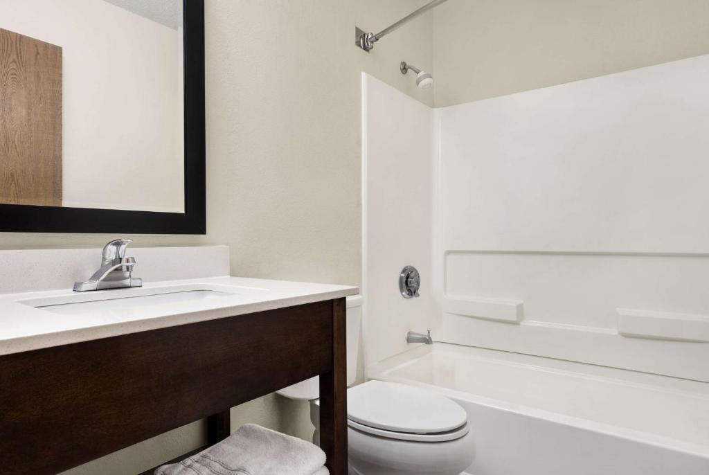 a bathroom with a white toilet and a sink at Super 8 by Wyndham Maysville KY in Maysville