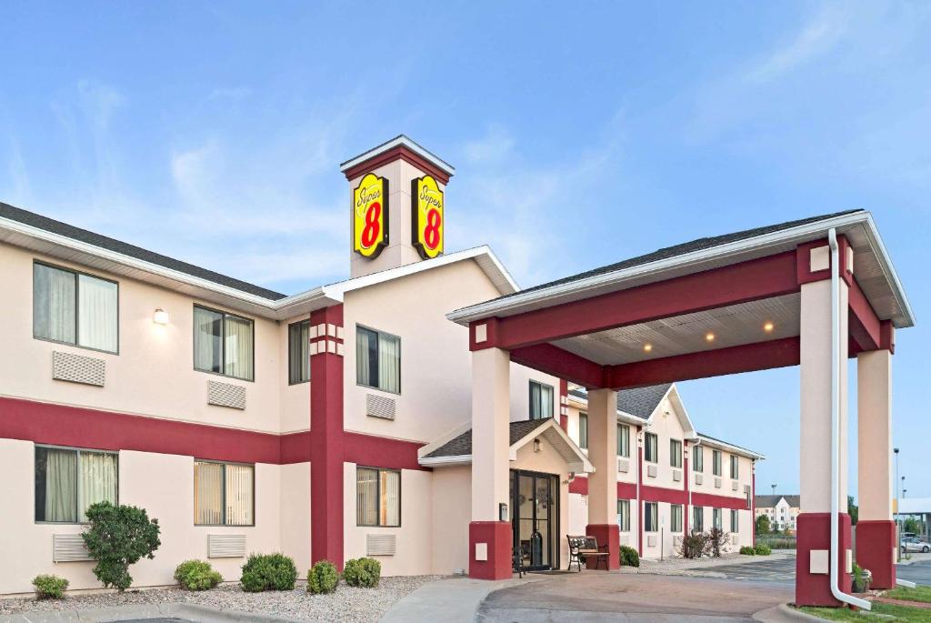 a hotel with a sign on top of it at Super 8 by Wyndham Omaha Eppley Airport/Carter Lake in Omaha