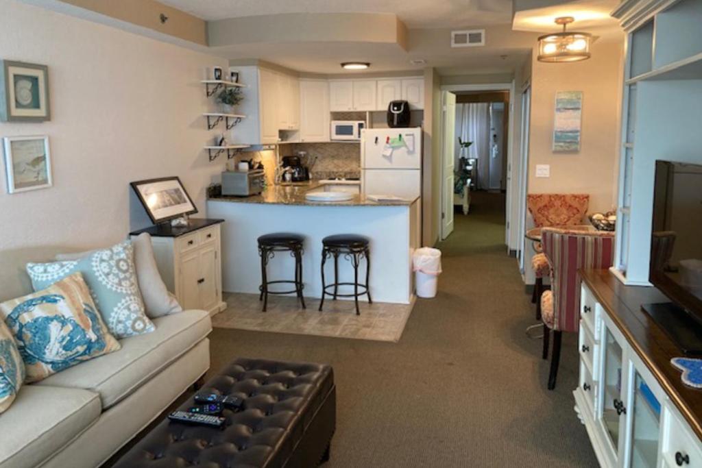 uma sala de estar com um sofá e uma cozinha em Daytona Beach Resort #215 em Daytona Beach