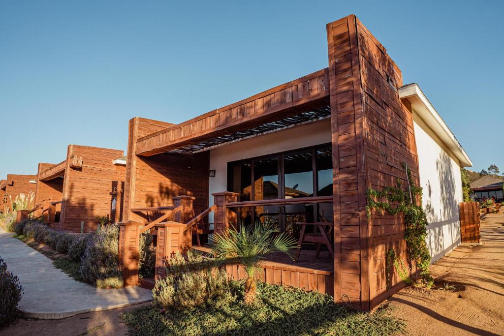 una casa de ladrillo con porche y patio en Entrevalle Hotel Boutique, en Valle de Guadalupe