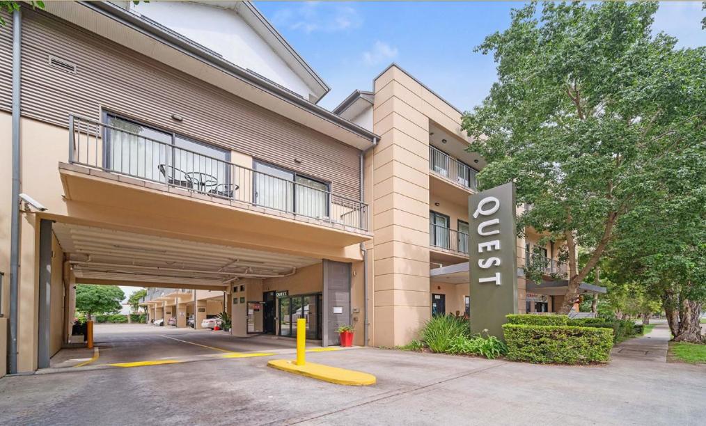 a building with a hotel sign in front of it at Quest Maitland in Maitland