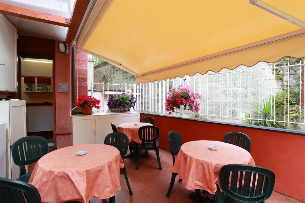 a dining area with tables and chairs and umbrellas at Albergo Al Carugio in Monterosso al Mare