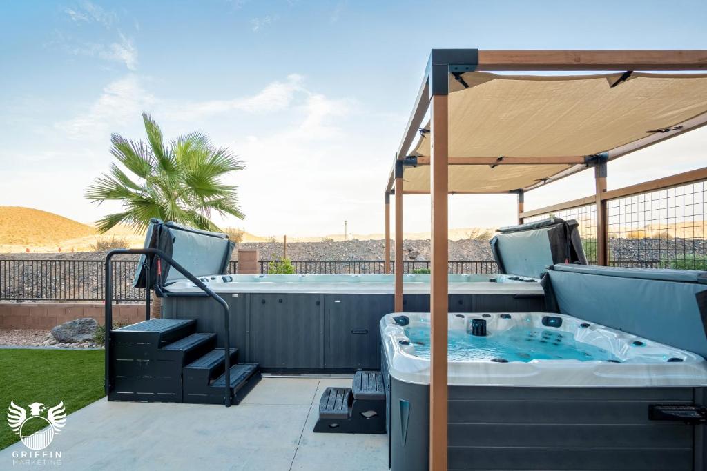 a hot tub on a patio with an umbrella at Zion Village Elements Earth in Hurricane