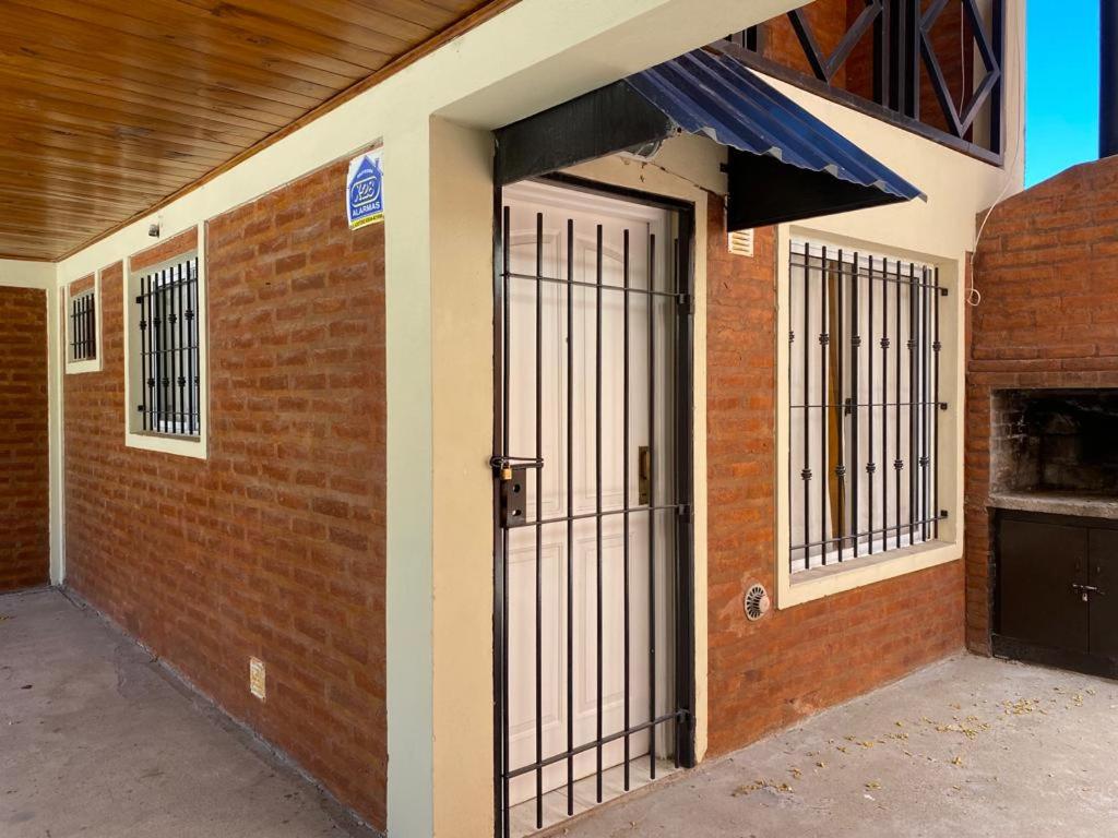 una entrada a un edificio de ladrillo con una puerta en Complejo Anita 07 en Las Grutas