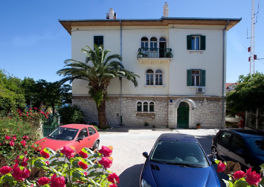 una casa con coches aparcados delante de ella en Apartment Mario en Split