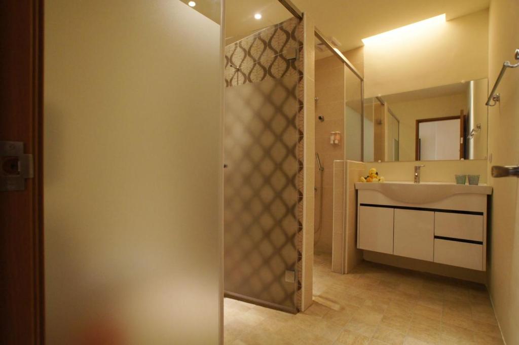 a bathroom with a sink and a mirror at Taitung Venice B&amp;B in Taitung City
